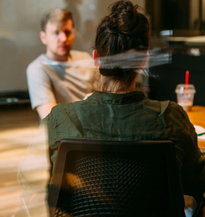 person sitting in a chair in front of a man